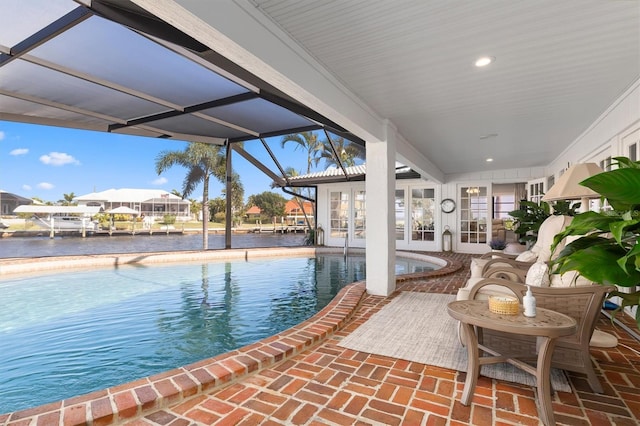 view of swimming pool with a lanai and a patio