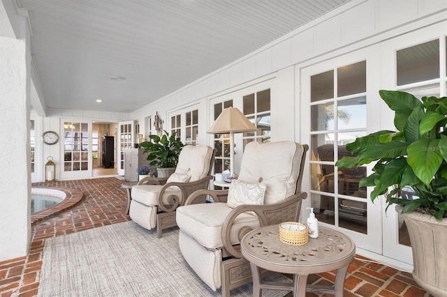 sunroom / solarium featuring french doors