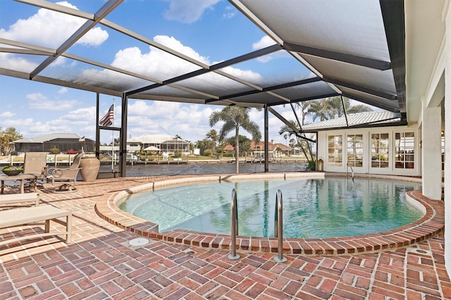 view of swimming pool with a lanai and a patio area