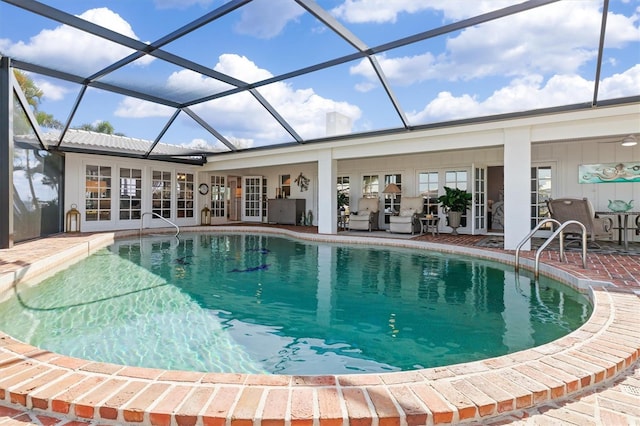 view of swimming pool featuring a patio, glass enclosure, and french doors