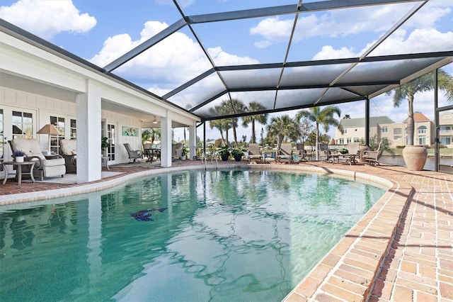 view of swimming pool with a patio and a lanai