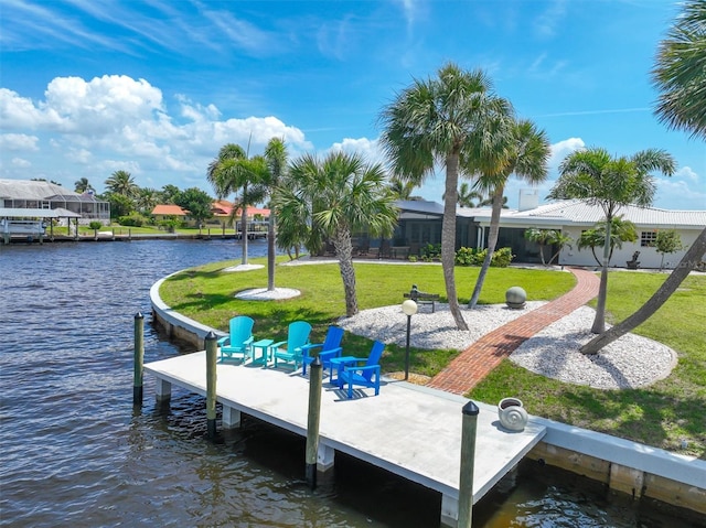 view of dock featuring a water view and a yard