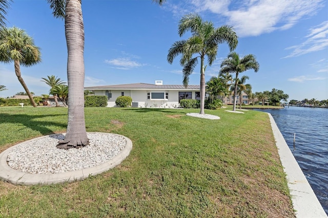 view of front of house with a water view and a front yard