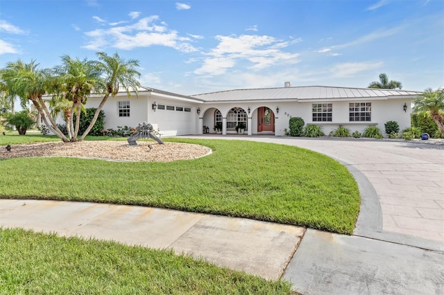 ranch-style home featuring a garage and a front lawn