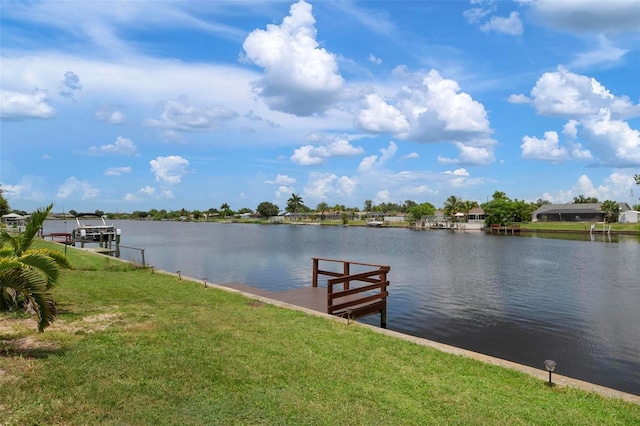 dock area with a water view and a lawn