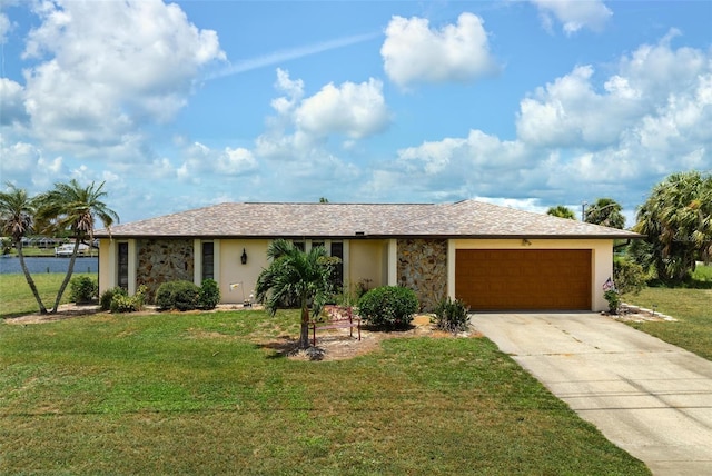 ranch-style house featuring a front yard and a garage