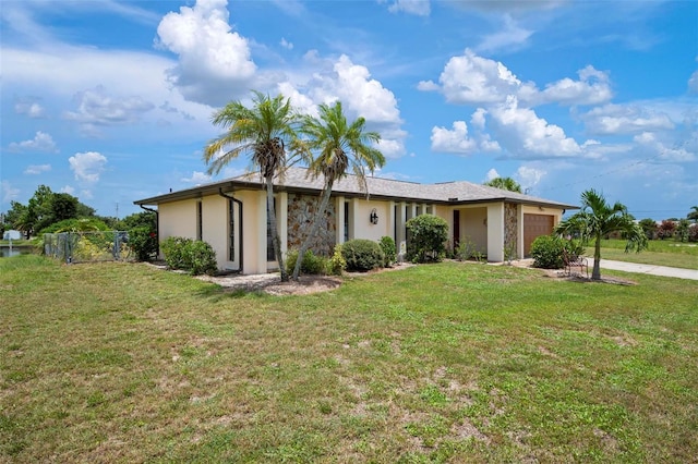 single story home featuring a garage and a front lawn