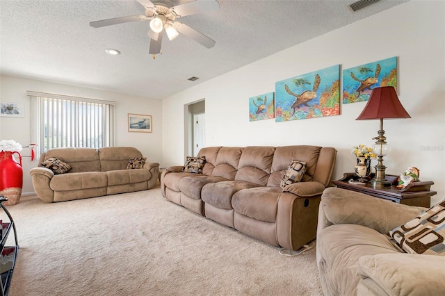 carpeted living room with ceiling fan and a textured ceiling