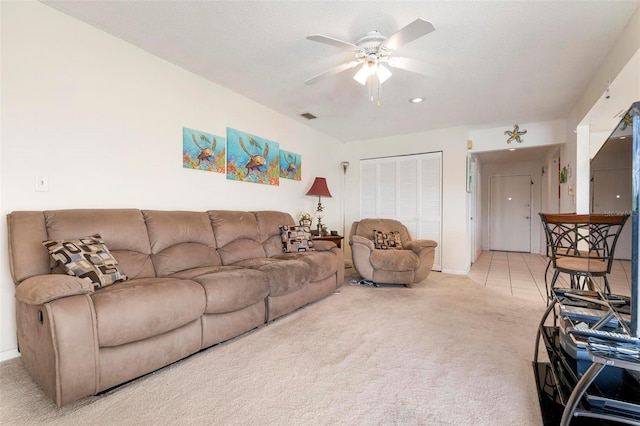 living room featuring ceiling fan and light colored carpet