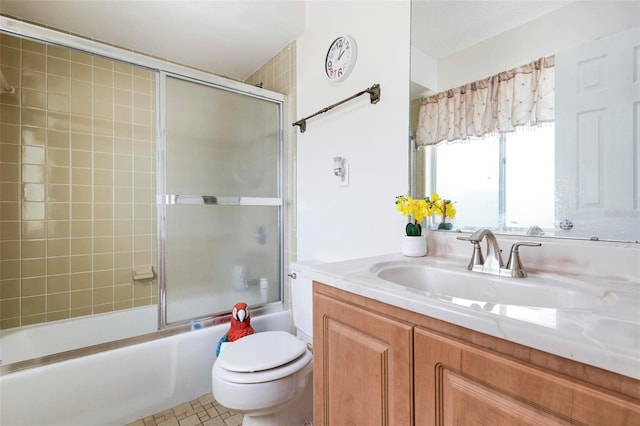 full bathroom featuring toilet, combined bath / shower with glass door, tile patterned flooring, and vanity