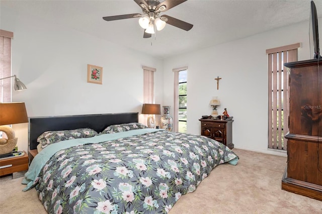 bedroom featuring ceiling fan and light carpet