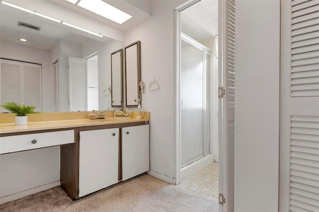 bathroom with an enclosed shower and vanity