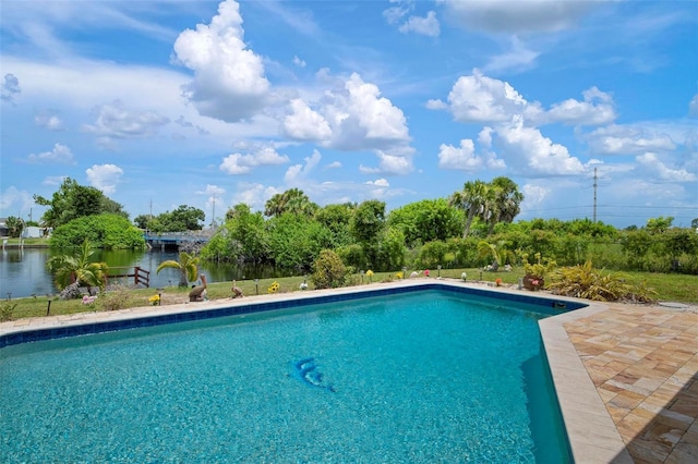 view of swimming pool featuring a water view