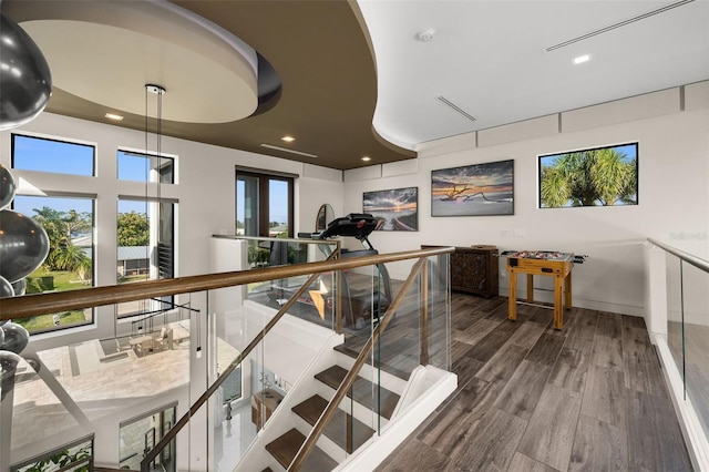 stairs featuring hardwood / wood-style floors