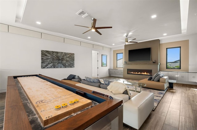 recreation room with ceiling fan and dark hardwood / wood-style floors