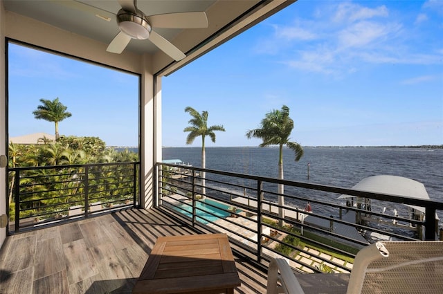 balcony featuring ceiling fan and a water view