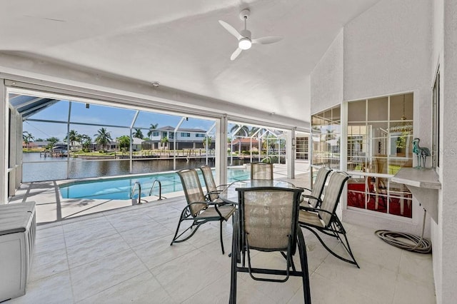 interior space featuring a water view, ceiling fan, and a swimming pool