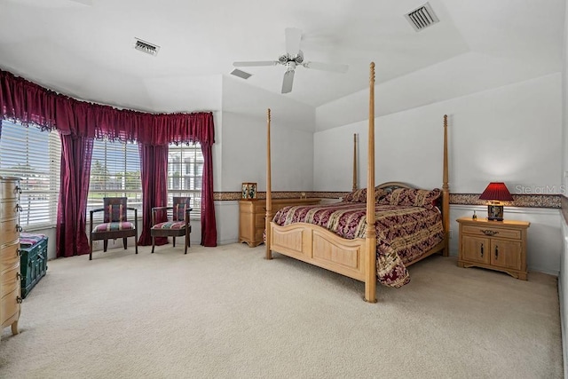 carpeted bedroom featuring ceiling fan, a tray ceiling, and lofted ceiling