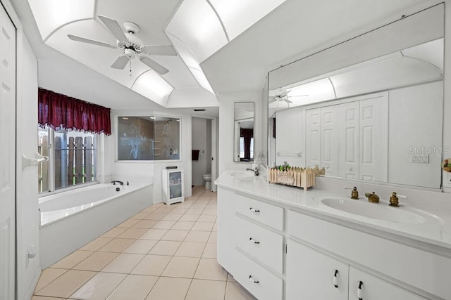 bathroom with toilet, ceiling fan, a bathtub, tile patterned flooring, and vanity