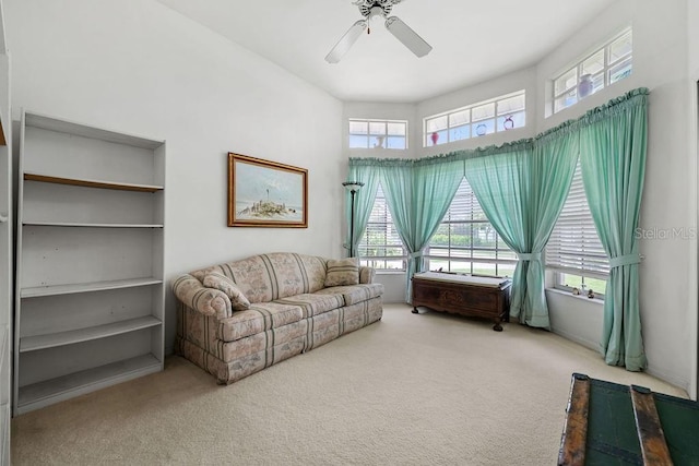 living area featuring ceiling fan and carpet flooring