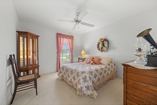 bedroom featuring ceiling fan and light colored carpet