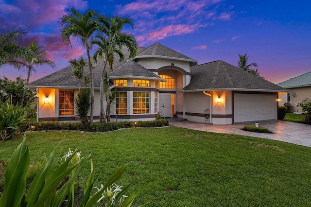 view of front of house with a garage and a lawn