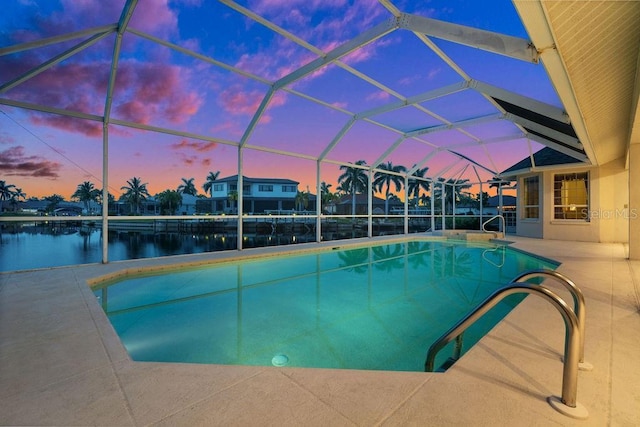 pool at dusk featuring a lanai, a water view, and a patio