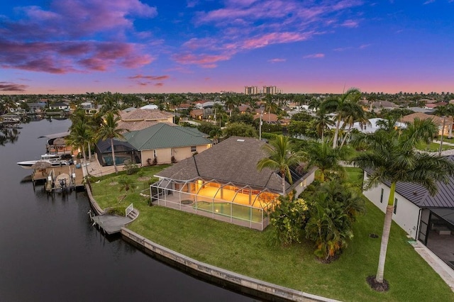 aerial view at dusk with a water view