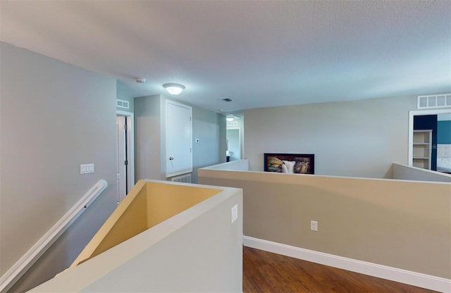 hallway with dark hardwood / wood-style floors