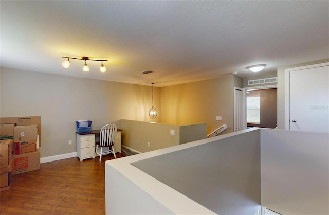 hall featuring dark hardwood / wood-style floors and a textured ceiling