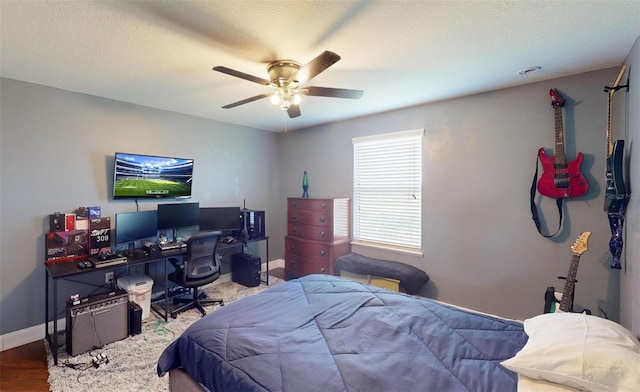 bedroom featuring hardwood / wood-style flooring, a textured ceiling, and ceiling fan