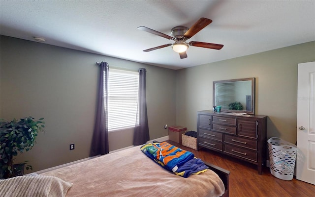 bedroom with dark wood-type flooring and ceiling fan