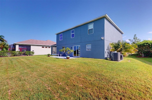 rear view of house featuring central AC unit and a yard