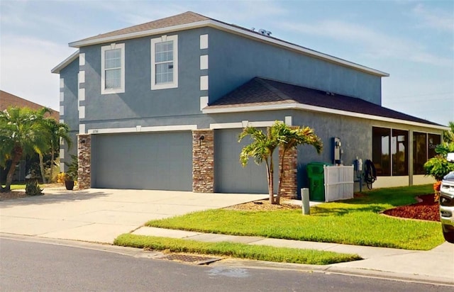 view of front of property featuring a garage and a front lawn