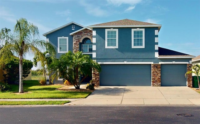 view of front of home with a garage and a front lawn