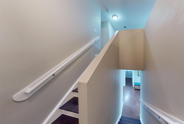 stairway with hardwood / wood-style floors