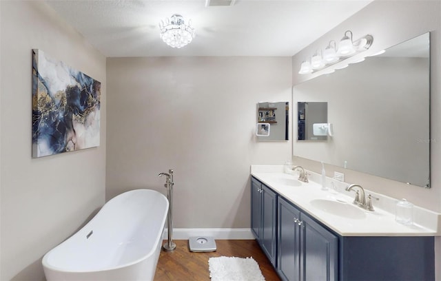 bathroom featuring vanity, wood-type flooring, and a bathtub