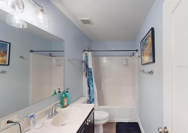 full bathroom with vanity, shower / bath combo, and toilet