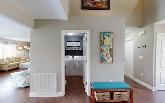 corridor featuring separate washer and dryer and dark hardwood / wood-style floors