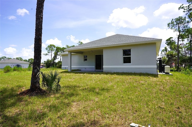 back of property featuring a lawn