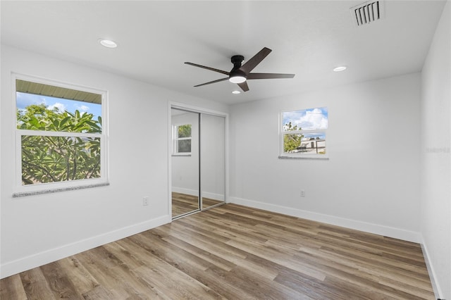 unfurnished bedroom with a closet, ceiling fan, and hardwood / wood-style flooring