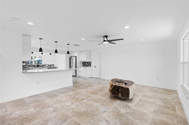 unfurnished living room featuring ceiling fan