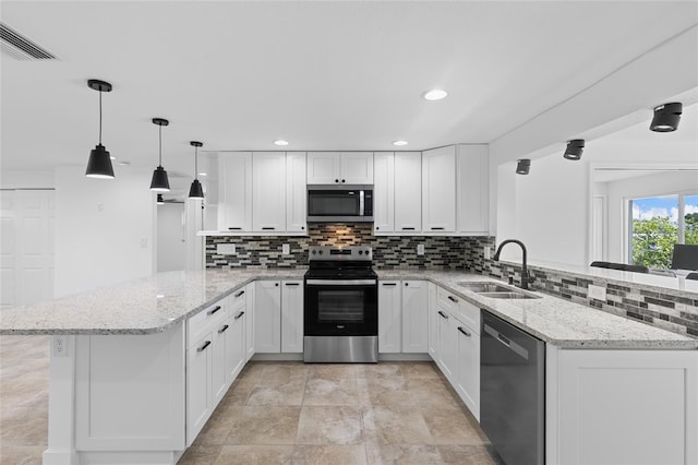 kitchen featuring stainless steel appliances, light stone countertops, kitchen peninsula, and white cabinets