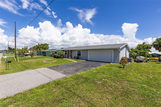 view of front of house featuring a front yard and a garage