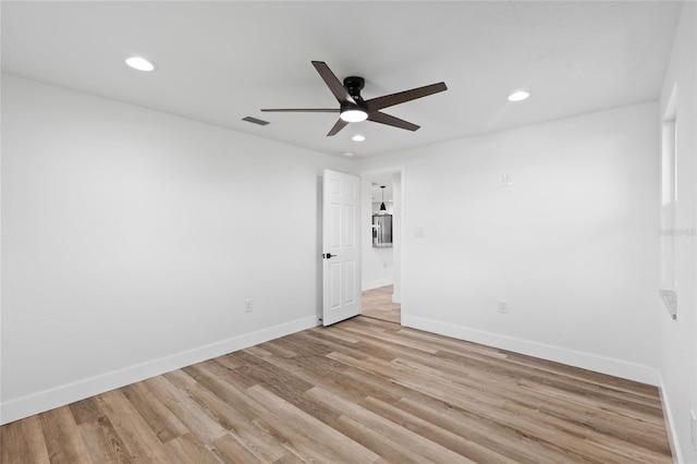 empty room with light hardwood / wood-style flooring and ceiling fan