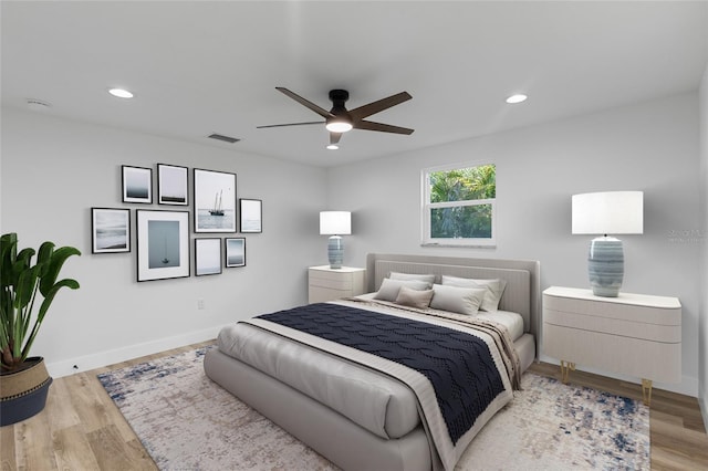 bedroom with light hardwood / wood-style floors and ceiling fan