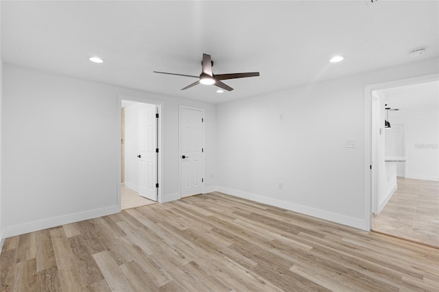 spare room with light hardwood / wood-style flooring and ceiling fan