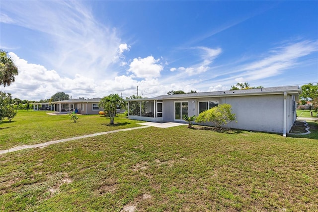 back of property with a patio and a lawn