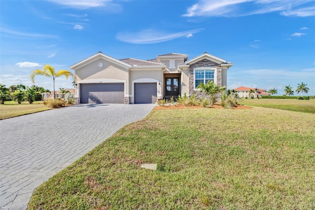 view of front of house featuring a garage and a front lawn