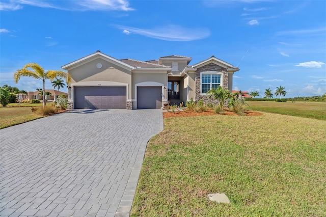 view of front of house with a garage and a front lawn